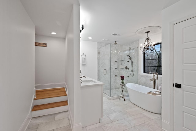 bathroom with an inviting chandelier, vanity, and shower with separate bathtub