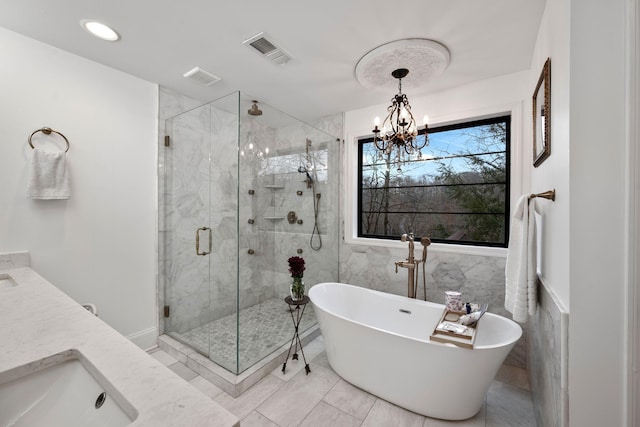 bathroom featuring vanity, shower with separate bathtub, tile walls, and an inviting chandelier