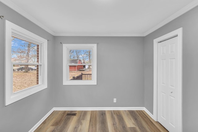 unfurnished room featuring hardwood / wood-style flooring and ornamental molding