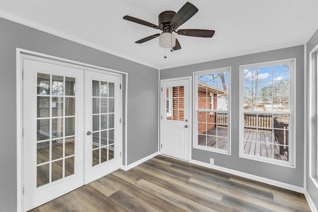 unfurnished sunroom featuring french doors and ceiling fan