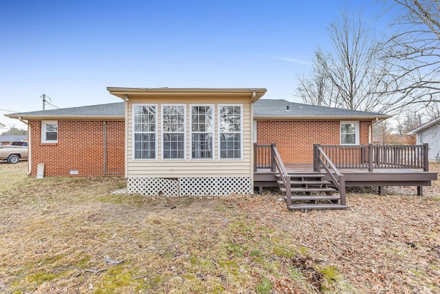 rear view of property with a wooden deck