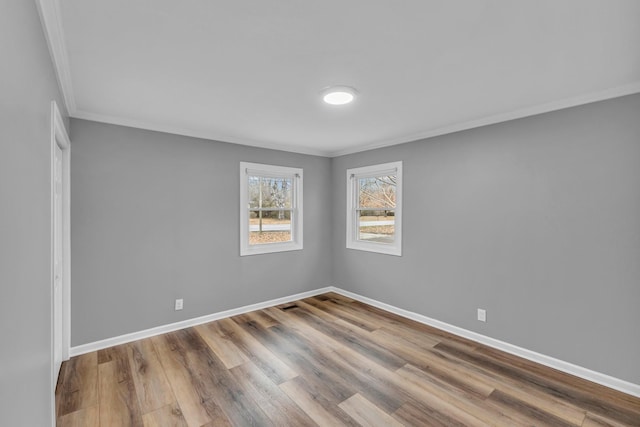 unfurnished room with crown molding and light wood-type flooring