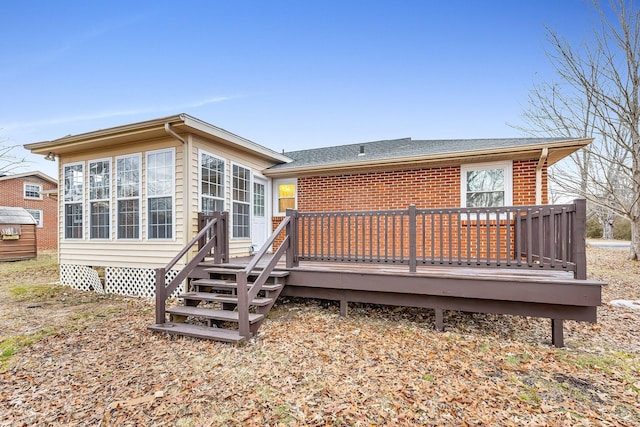 back of property featuring a wooden deck