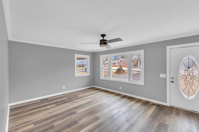 entryway with hardwood / wood-style flooring, ornamental molding, and ceiling fan