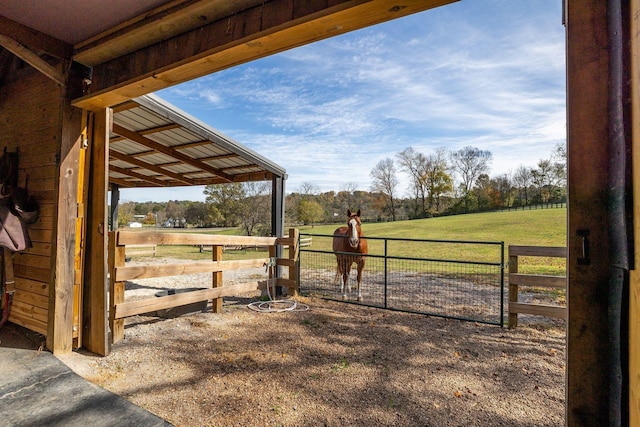 view of horse barn with a rural view