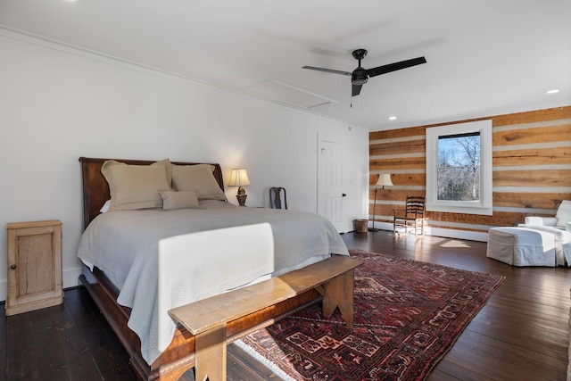 bedroom with crown molding, wooden walls, dark hardwood / wood-style floors, and ceiling fan