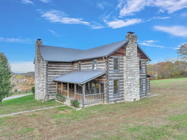 log home with a porch and a front yard