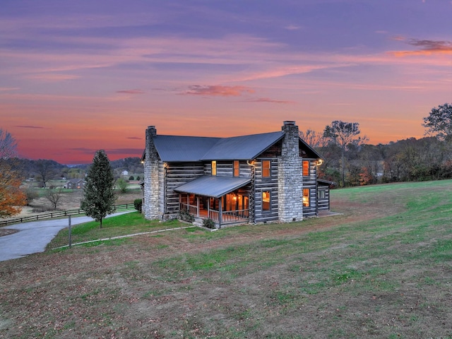 log cabin featuring a yard