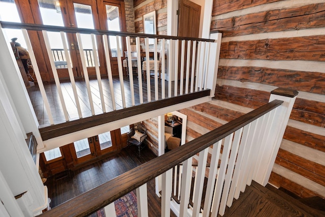 stairs featuring hardwood / wood-style floors