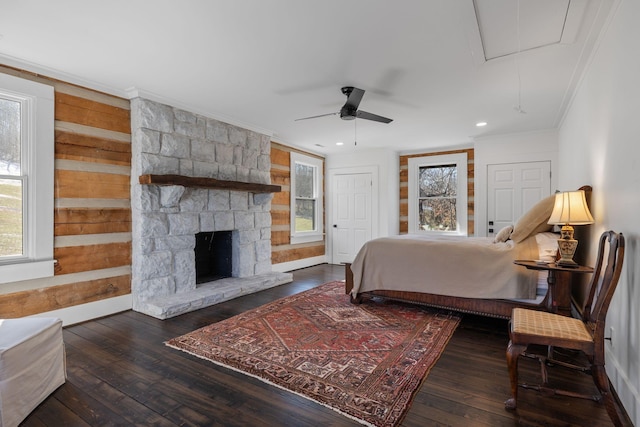 bedroom featuring multiple windows, dark hardwood / wood-style flooring, and ornamental molding