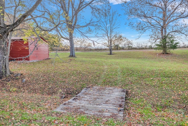 view of yard with a rural view and a storage unit