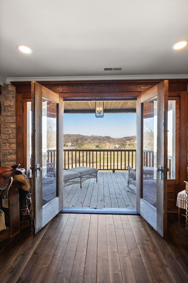 doorway to outside featuring ornamental molding, a mountain view, and dark wood-type flooring