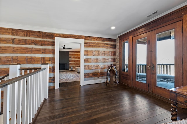 interior space with crown molding, dark hardwood / wood-style floors, and french doors