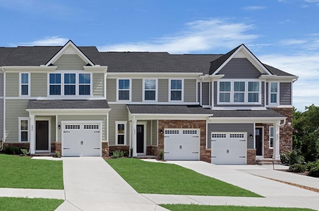 craftsman inspired home with a garage and a front yard