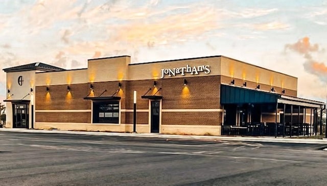 view of outdoor building at dusk