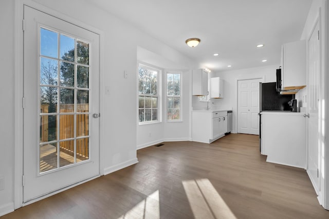 kitchen featuring white cabinetry, sink, and light wood-type flooring