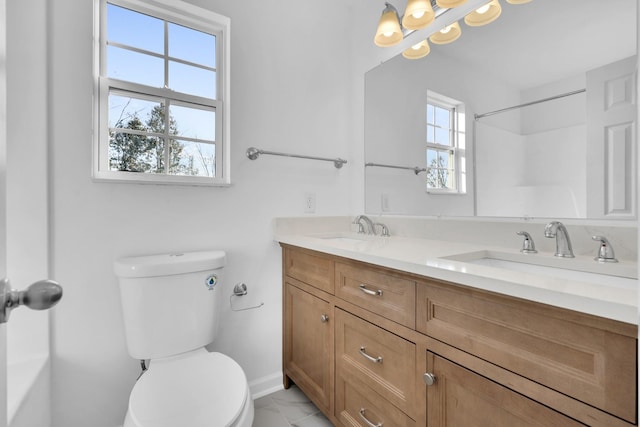 bathroom featuring vanity and toilet