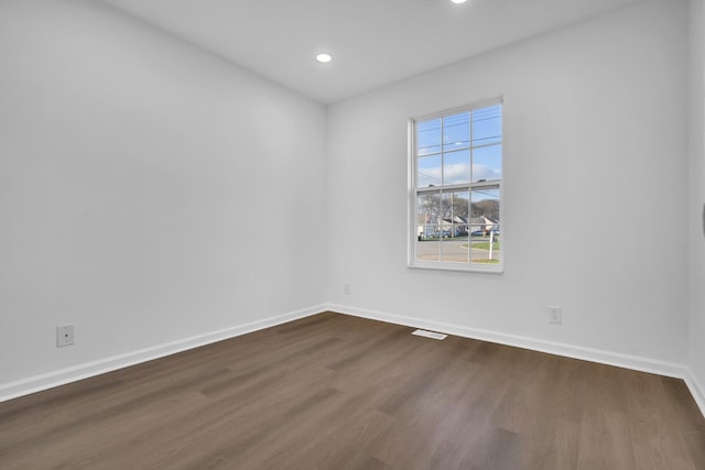 empty room with dark hardwood / wood-style floors