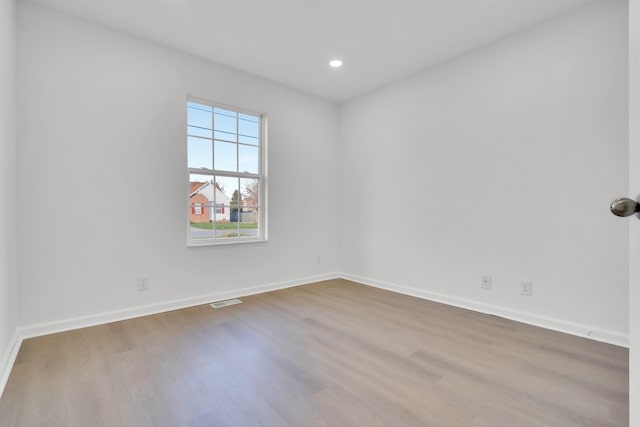 empty room with hardwood / wood-style floors