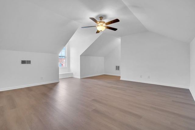 additional living space with vaulted ceiling, ceiling fan, and hardwood / wood-style floors