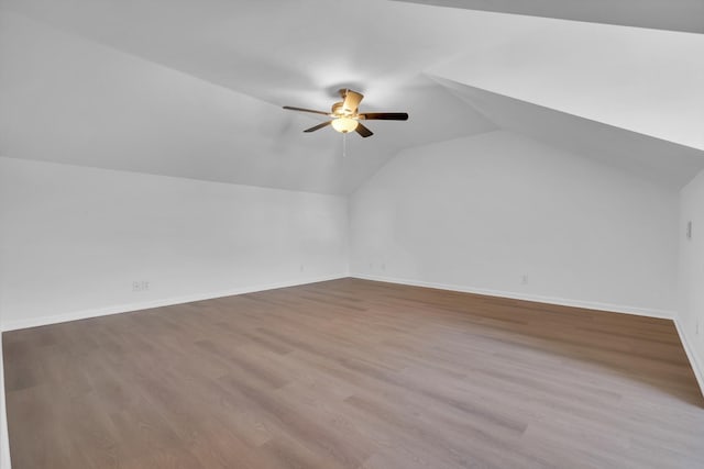 additional living space with vaulted ceiling, ceiling fan, and light hardwood / wood-style flooring