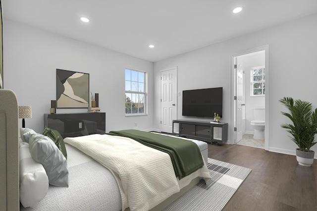 bedroom featuring dark wood-type flooring and ensuite bathroom