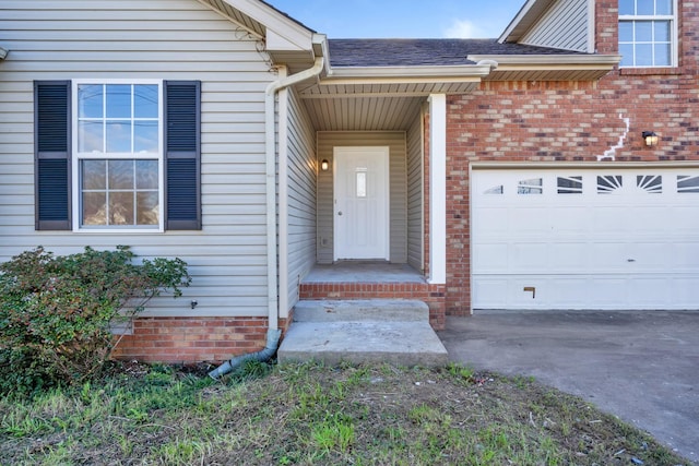 view of exterior entry with a garage