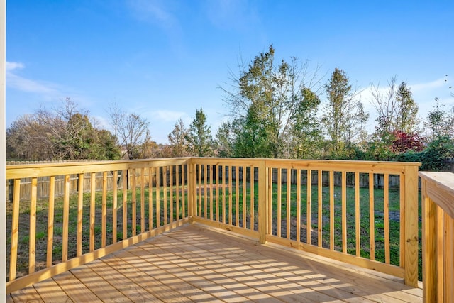 wooden deck featuring a yard