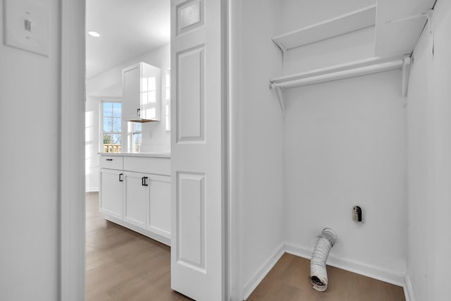 laundry area featuring light hardwood / wood-style flooring