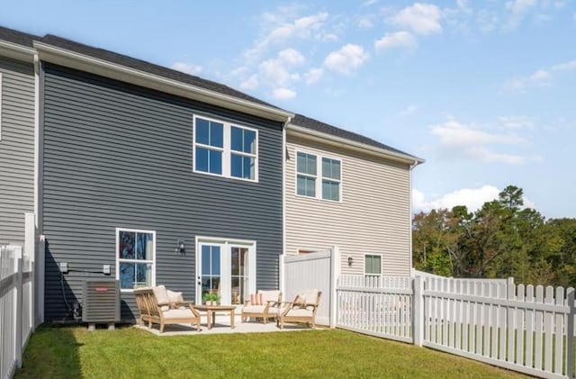 back of property featuring a patio area, outdoor lounge area, and a lawn