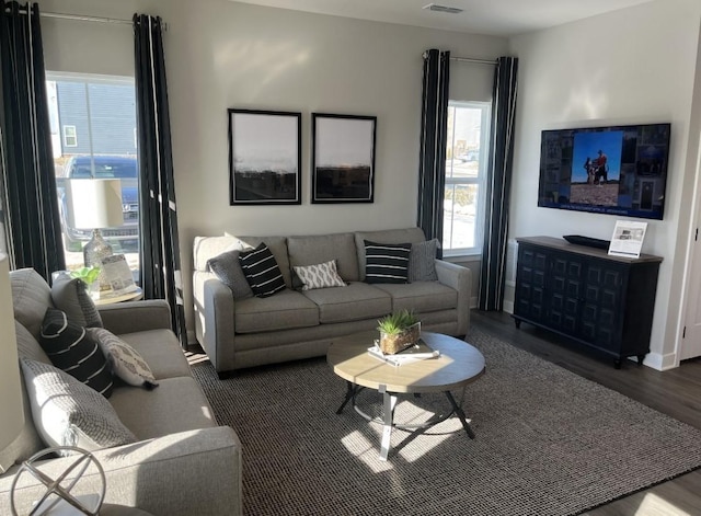 living room with dark hardwood / wood-style flooring