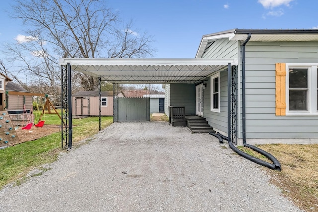 view of side of property with a carport and a storage shed