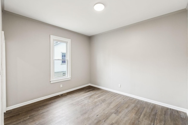 unfurnished room with wood-type flooring