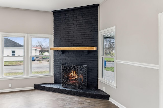 room details with hardwood / wood-style flooring, ornamental molding, and a fireplace