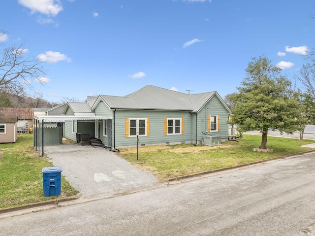 view of front of house with cooling unit, a carport, and a front lawn