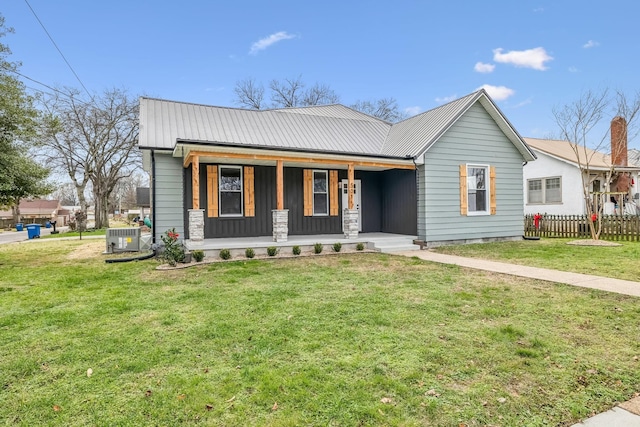 view of front of property featuring central AC unit, a front lawn, and covered porch