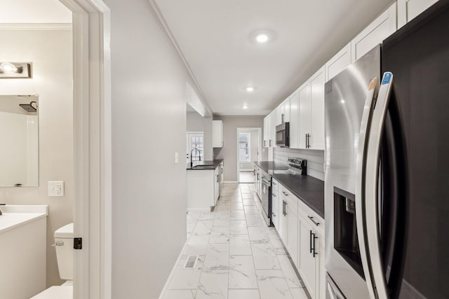 kitchen featuring stainless steel appliances and white cabinets