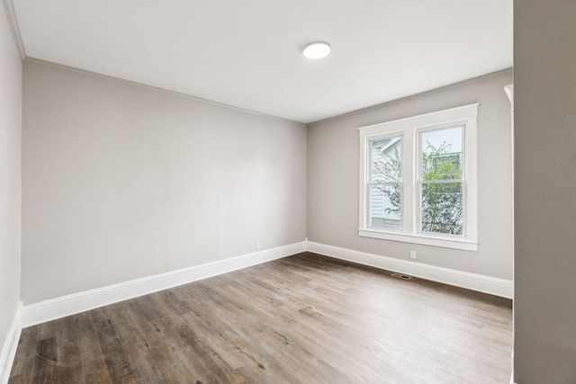 spare room with hardwood / wood-style flooring