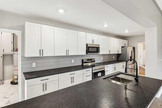 kitchen featuring white cabinetry, sink, and appliances with stainless steel finishes