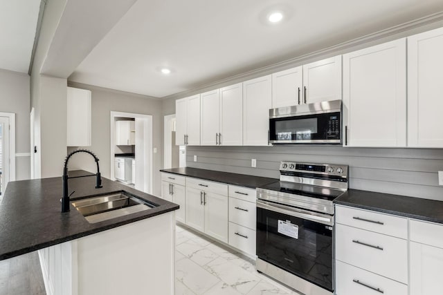 kitchen featuring white cabinetry, an island with sink, stainless steel appliances, and sink