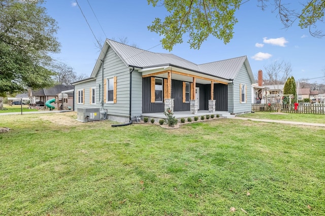 view of front of property with a porch, cooling unit, and a front lawn