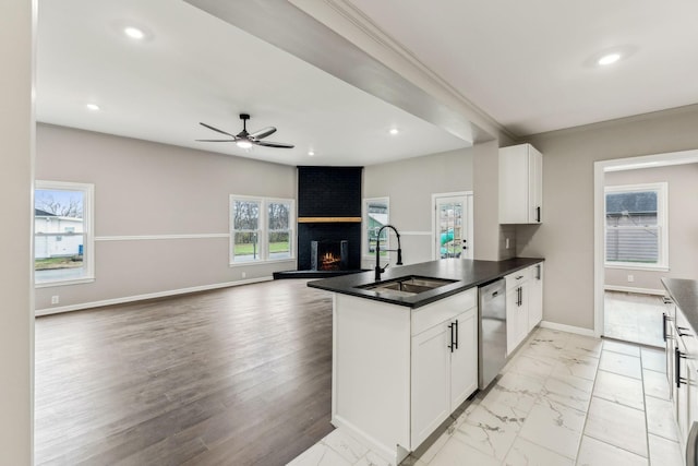 kitchen featuring white cabinetry, dishwasher, sink, and kitchen peninsula