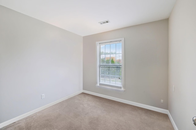 unfurnished room with light colored carpet