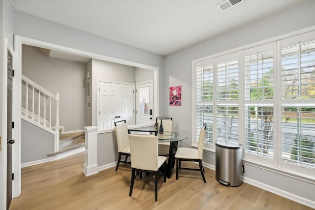 dining area with a healthy amount of sunlight and light hardwood / wood-style floors