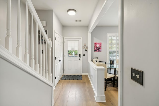 foyer entrance with light hardwood / wood-style floors