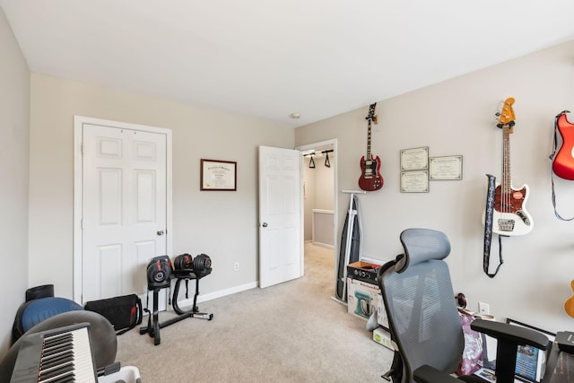 exercise room featuring light colored carpet