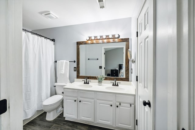 bathroom featuring hardwood / wood-style flooring, vanity, a shower with curtain, and toilet