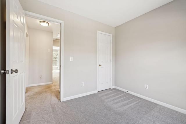 unfurnished bedroom with baseboards and carpet