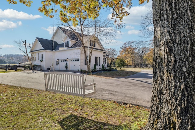 view of side of home with a garage and a yard