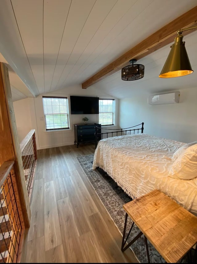 unfurnished bedroom with beamed ceiling, wood-type flooring, a wall unit AC, and multiple windows